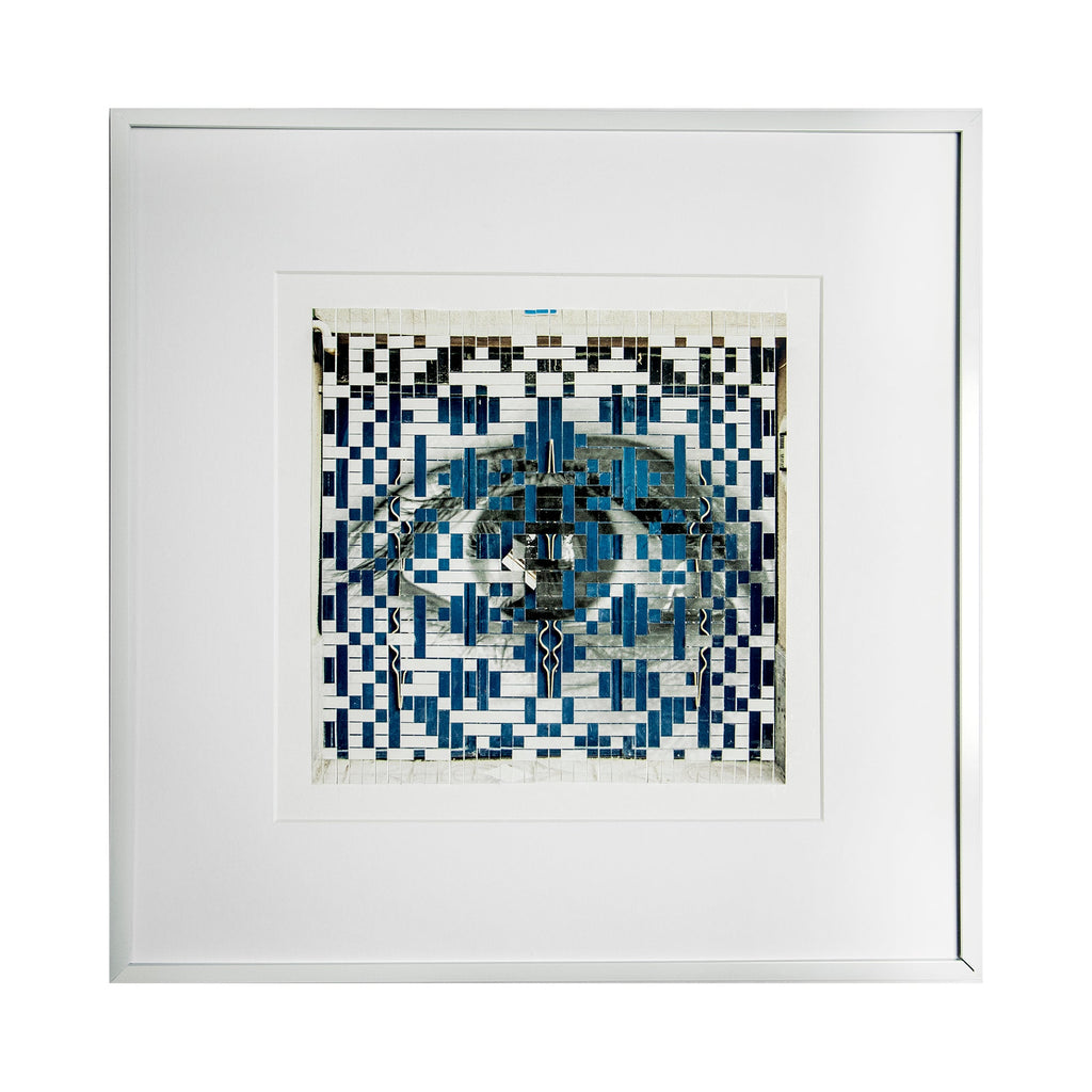 The artwork 'The Blue Door' by Kiana Honarmand features an intricate geometric pattern in black and vibrant blue tones, created through hand-cut and woven giclee prints. The 18x18 inch piece showcases a symmetrical mosaic-like design with a central doorway motif, surrounded by pixelated patterns reminiscent of traditional Persian architectural elements. The composition balances negative white space with bold geometric shapes. By Kiana Honarmand.