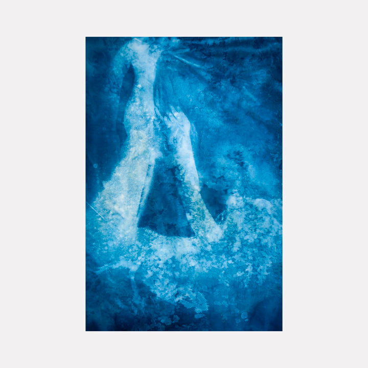The artwork "Isabella" by Cat Welch features a textured, abstract composition in deep blue tones with ethereal white forms resembling human figures reaching upward. The style evokes the atmospheric and poetic qualities found in works by Mark Rothko and Helen Frankenthaler, blending fluid shapes and rich color gradients to create a sense of depth and emotion.