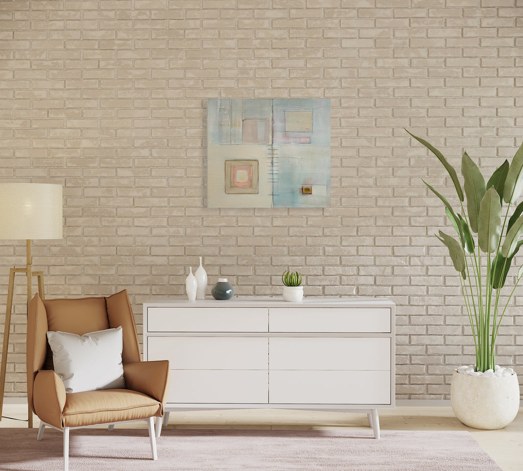 The artwork 'NORTHEAST' by Nina Meledandri features abstract geometric squares and rectangles in soft pastel hues of cream, pale blue, and blush pink. Textural brushstrokes and graphite lines create a minimalist composition with subtle layering effects. The oil painting showcases delicate color transitions and architectural elements on canvas.