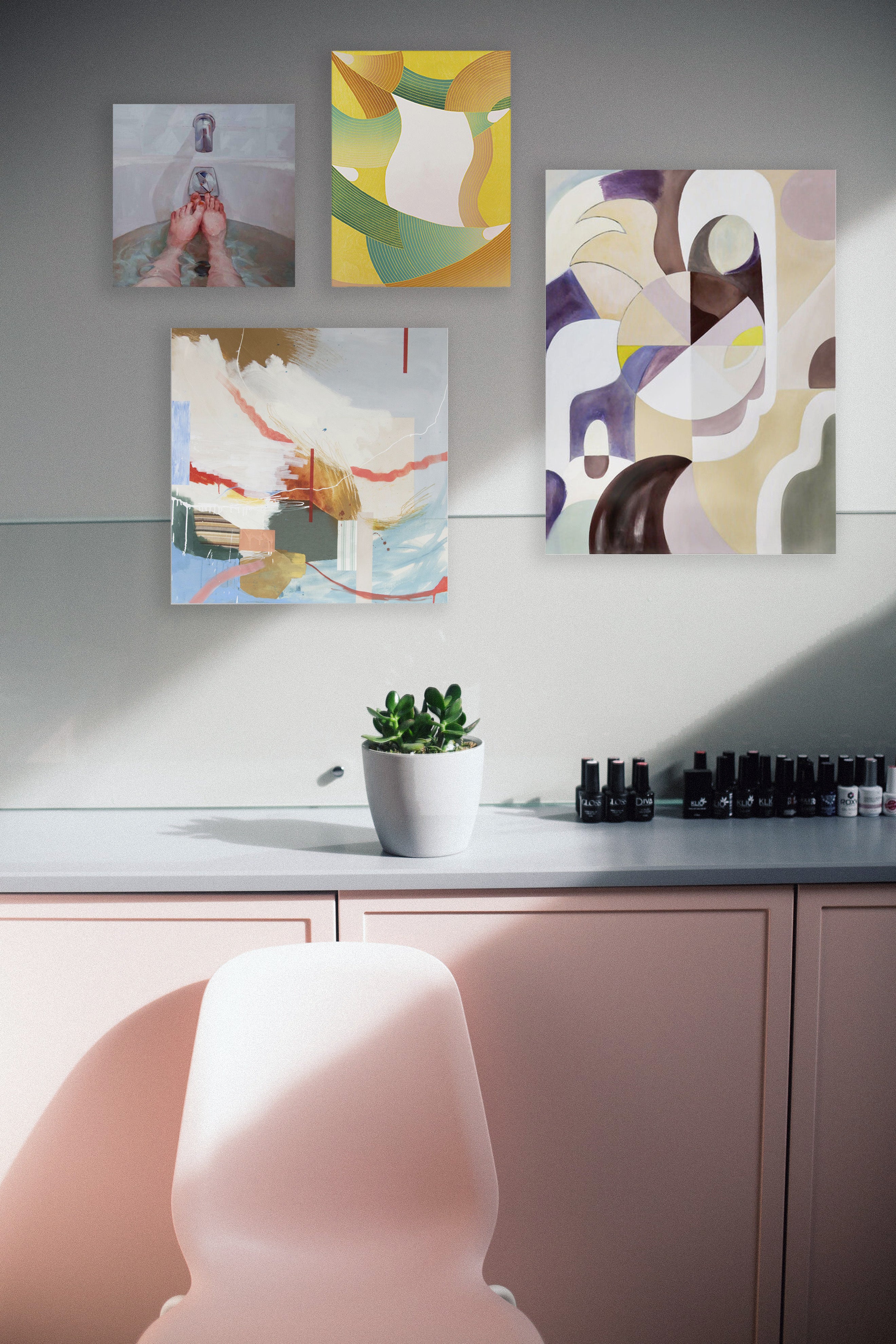 gallery art wall with 4 artworks in a soft pink room
