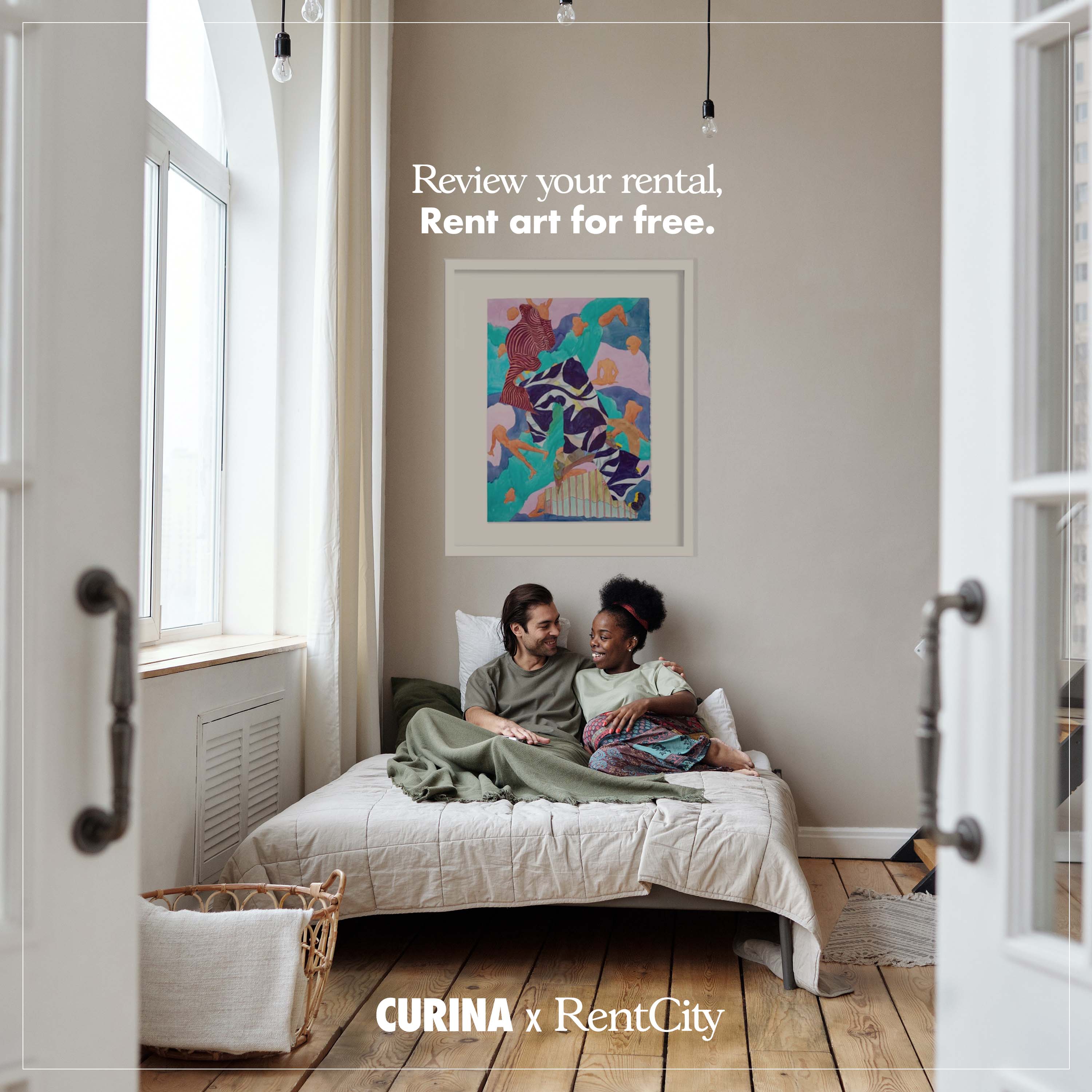 A couple sitting on a chic bed against a contemporary artwork from Curina