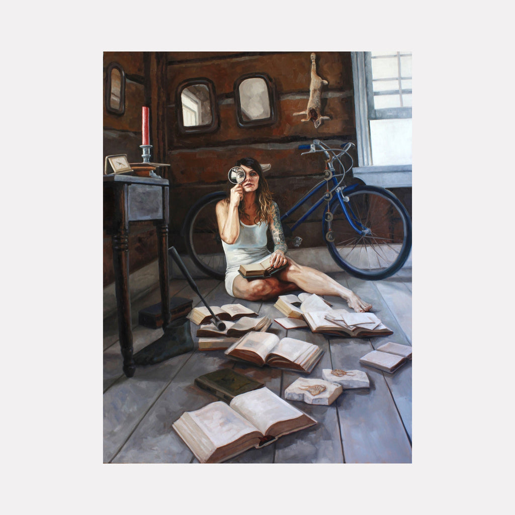 The artwork 'He and We and One, Two, Three' by Elody Gyekis depicts a contemplative scene in warm browns and blues. A figure sits on wooden flooring surrounded by scattered open books, beside a vintage-style blue bicycle. A red candle sits atop a dark stand, while rustic windows adorn the wooden walls. Oil on canvas, 48x36 inches. By Elody Gyekis.