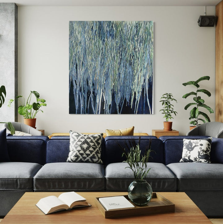 The artwork 'Fall' by Seren Morey features cascading vertical lines in shades of blue, silver, and sage green, creating a textural abstract pattern reminiscent of forest rain or melting icicles. Created with encaustic and urethane on panel, the piece showcases a dynamic dripping technique that adds depth and movement to the 66x60 inch composition.