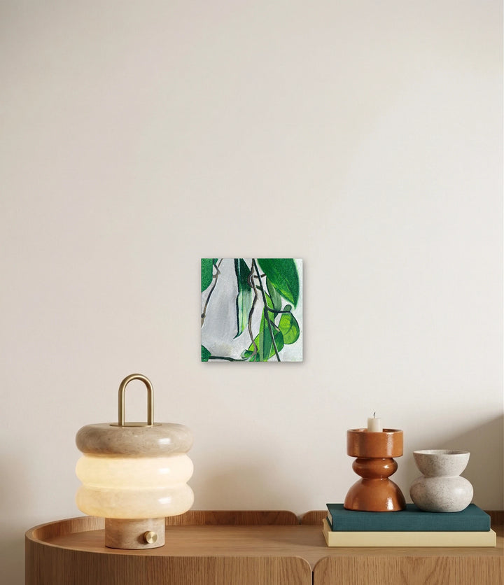 The artwork, And With the Right Care, They Can Bloom Regularly., by Jessica Preble, displayed in a room.