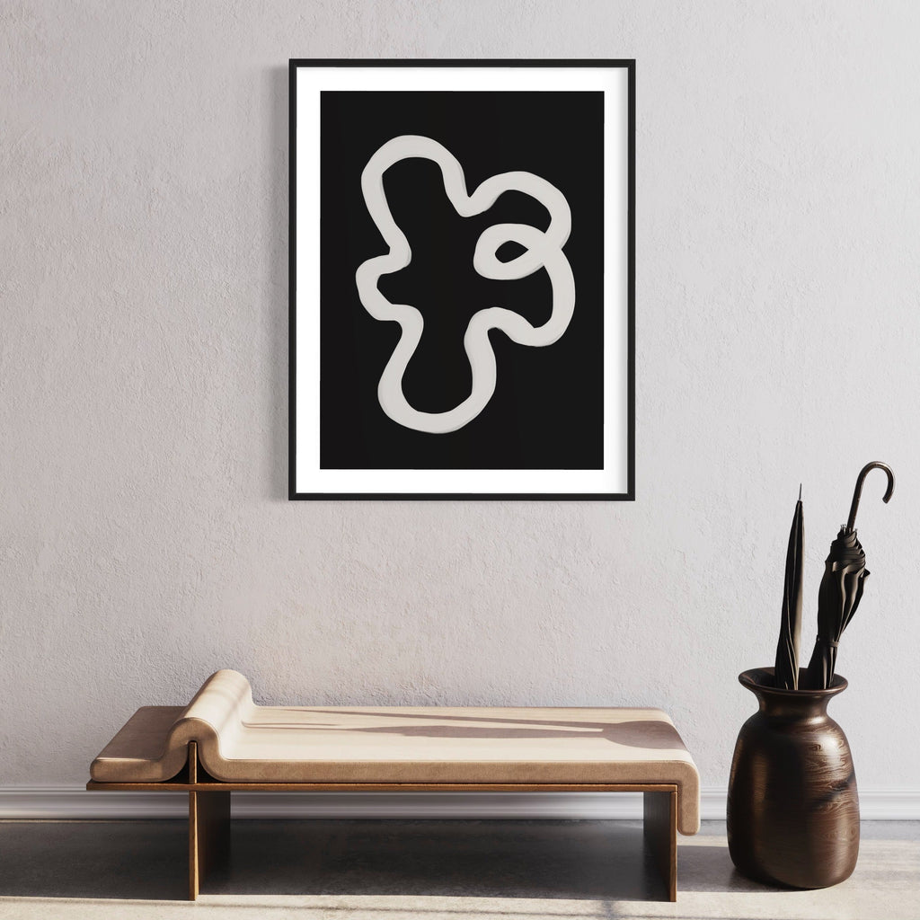 The artwork 'Infinity Shape' by Alina Glotova features a bold, minimalist design with a continuous white curved line forming an abstract organic shape against a stark black background. The modern print, presented in a black frame, creates a striking monochromatic contrast that exemplifies contemporary abstract art. By Alina Glotova.