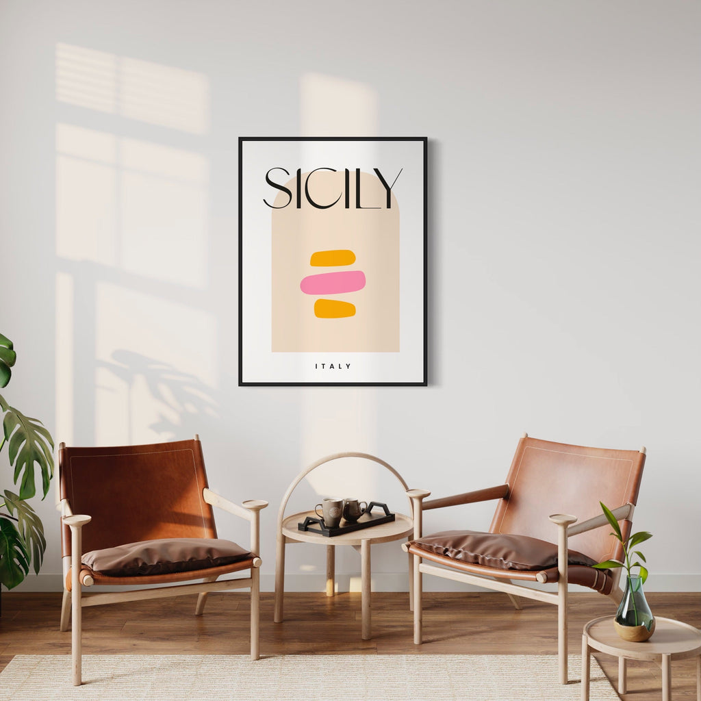 Sicily Travel Poster by Alina Glotova features a minimalist design with abstract geometric shapes in warm orange and pink tones against a soft beige background. The artwork displays elegant typography with SICILY text centered above the shapes, framed in black, showcasing modern Scandinavian-inspired interior styling in a 40x30 inch print format.