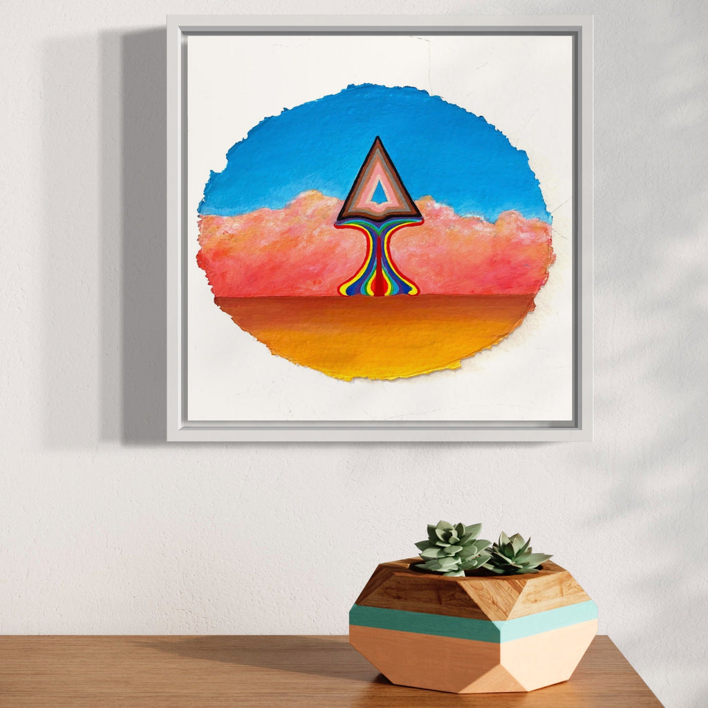 The artwork 'Emergence' by Jacki Davis features a striking geometric arrow-like form rising from an orange horizon against a coral pink landscape and vibrant blue sky. The abstract shape showcases rainbow-colored layers within, creating a psychedelic effect in this framed giclee print on watercolor paper.