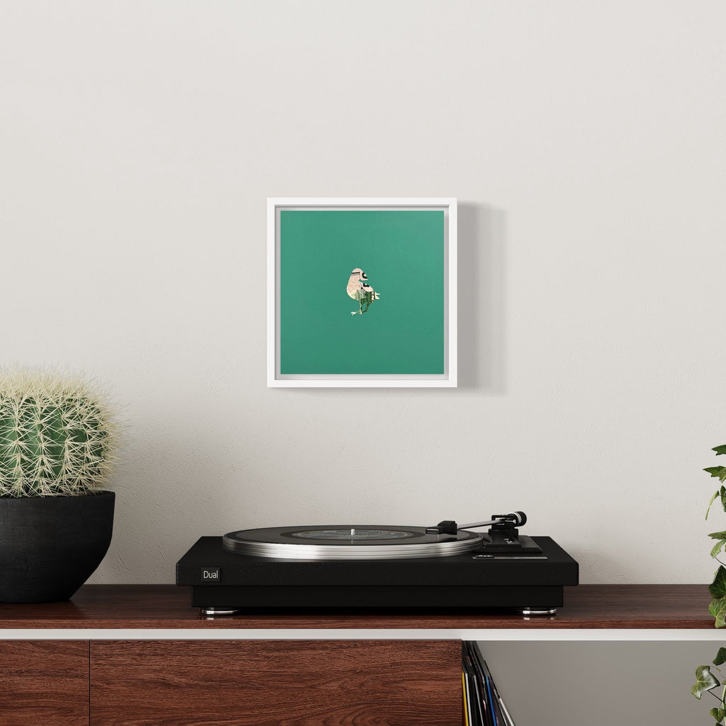 The artwork 'Profit Margins, Puffin' by Jacki Davis features a minimalist white puffin illustration centered on a vibrant emerald green background, framed in white. Created using US currency and acrylic on wood panel, this 8x8 inch piece combines contemporary design with mixed media artistry by Jacki Davis.