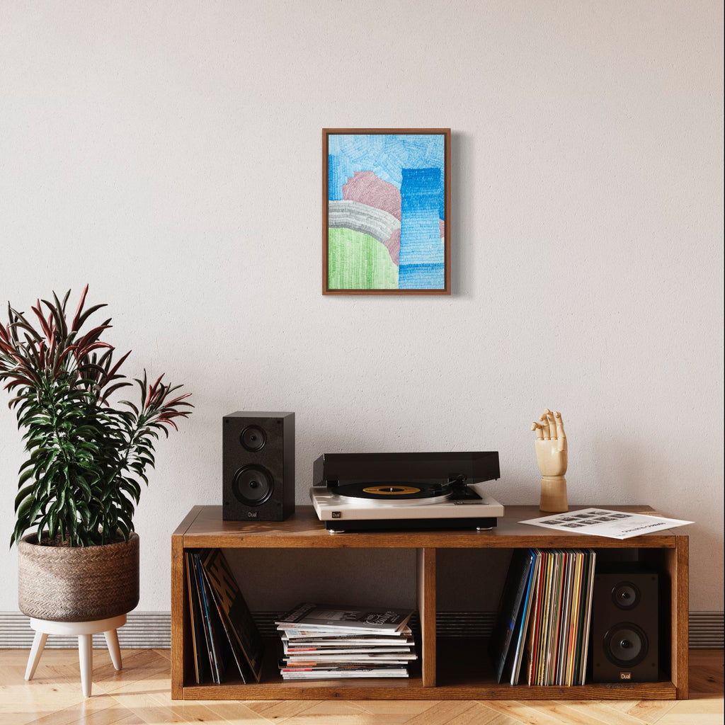 The artwork 'Still' by Lynnette Therese Sauer features abstract geometric shapes in soft pastel colors. A gentle pink curved form rests against a mint green horizontal element, set against a graduated blue sky background. The ink on paper piece is displayed in a brown wooden frame, creating a serene, minimalist composition measuring 16 x 12 inches by Lynnette Therese Sauer.