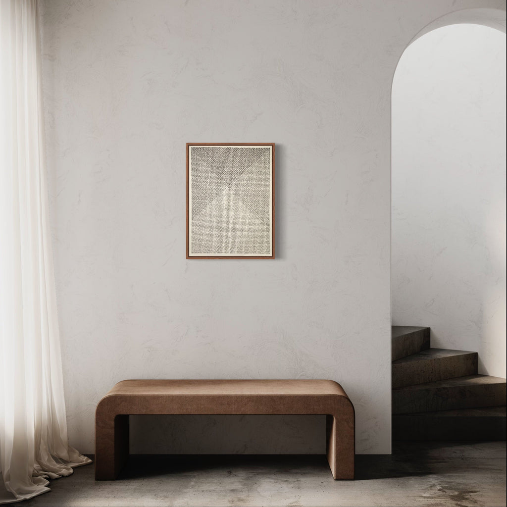 The artwork 'Meditation XXIII (open heart)' by Lynnette Therese Sauer features a minimalist ink drawing on paper displaying intricate dotwork forming a geometric pyramid pattern in subtle beige tones. Framed in warm wood, the piece hangs above a curved brown bench in a serene, white-walled space with arched doorway, creating a contemplative atmosphere. 24x18 inches, ink on paper.