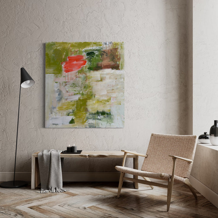 The artwork 'The Grass Always Seems Greener on the Other Side' by Petra Nimtz features an abstract composition with bold strokes of olive green and coral red against a white background. The oil on linen painting showcases dynamic brushwork, textural elements, and dripping effects, creating a modern expressionist aesthetic. The 49x45 inch piece demonstrates layered techniques and ethereal color transitions.