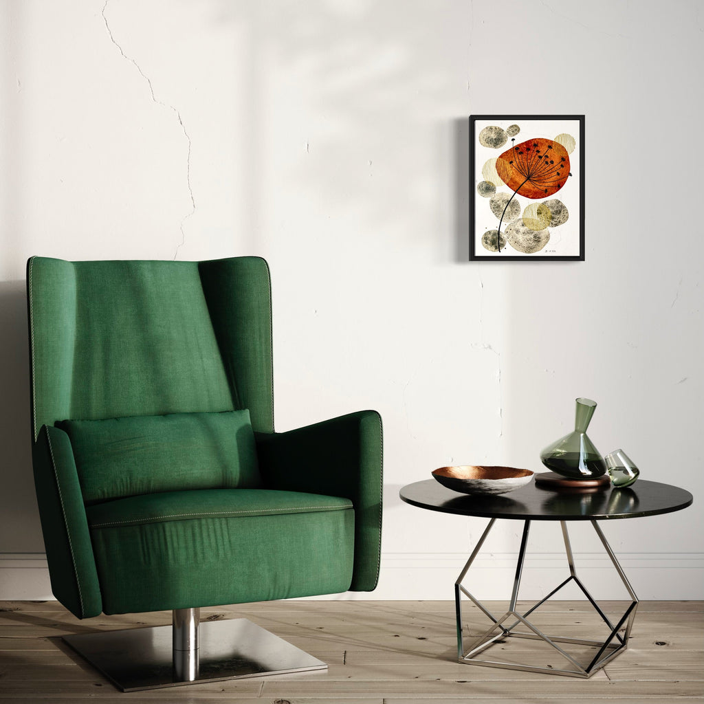 The artwork 'Le Beau Nerac' by Jocelyn Benford features a vibrant orange-red poppy bloom against delicate beige floral elements, rendered in watercolor and mixed media. The piece, framed in black, displays a contemporary botanical style with expressive brushwork and textural details, hanging above an emerald green armchair and round side table by Jocelyn Benford.