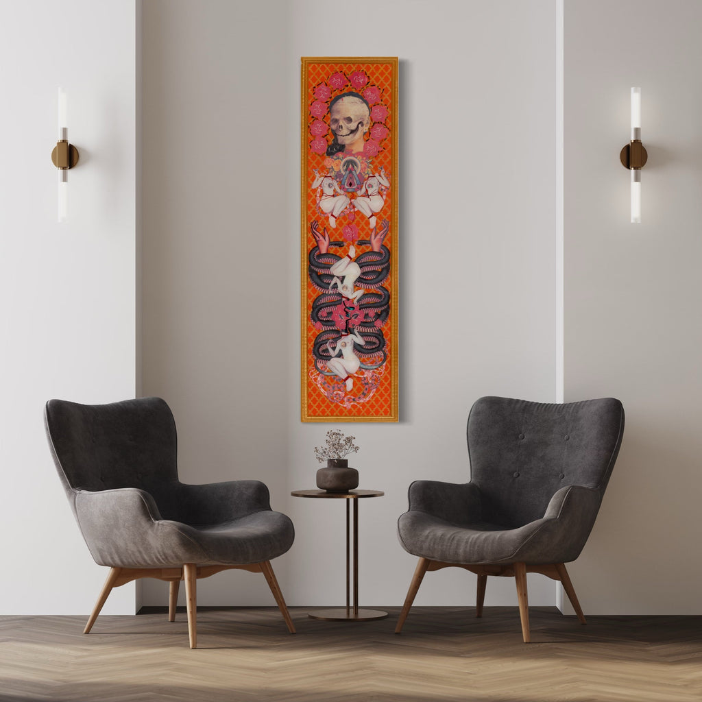 The artwork 'Skull with Snake and Gold Figures' by Chelsea Amato features a vertical mixed media collage set against a vibrant orange background with intricate geometric patterns. A central skull motif is surrounded by ornate gold embellishments, while intertwined black and white snakes create a symmetrical design. Red and coral accents complement the composition, with detailed lacework patterns framing the main elements. Mixed media on panel, 60