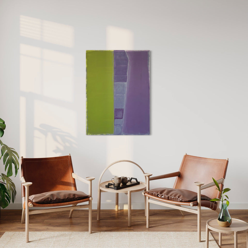 The artwork 'Interstices (chartreuse & violet)' by Cora Jane Glasser features a bold vertical composition with striking chartreuse green and violet panels divided by subtle geometric forms. Created with oil and wax-based pencil on stretched linen, the minimalist abstract painting displays rich textures and a dynamic interplay of cool and warm tones. The 40x30 inch artwork creates a sophisticated focal point against a white wall.
