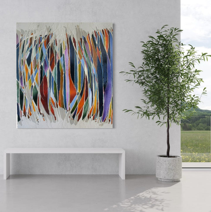 The artwork 'Loss and Longing' by Seren Morey features dynamic vertical streaks in vibrant colors of blue, orange, red, and purple, intertwined with white flowing elements. The encaustic and urethane medium creates a textured, dimensional effect on the panel, resembling abstract stalactites or elongated brush strokes arranged in a rhythmic, cascading pattern.