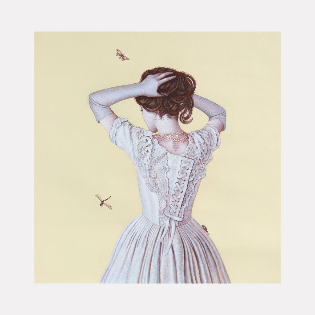 Pearls and Gloves IV by Carlos Gamez de Francisco is a Curina art piece showing a woman in a vintage lace dress and long gloves, her back turned as she holds her hair up, with delicate pearl jewelry and soft insects against a muted, pale yellow background.