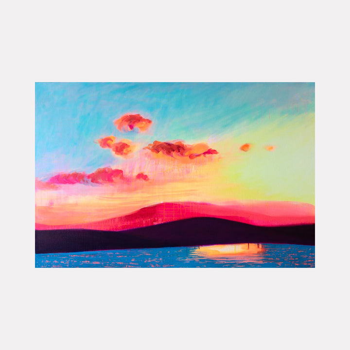 Dingle Bay by Melanie Kozol is a Curina art piece capturing a vibrant sunset over silhouetted hills with glowing pink and orange clouds reflected in calm blue waters, blending vivid color contrasts and soft atmospheric effects in a serene coastal landscape.