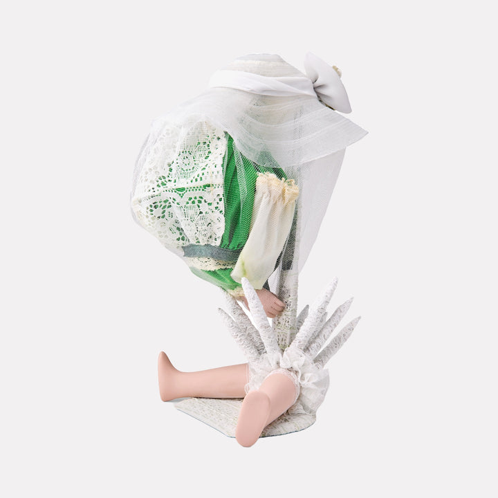 Green in Morning by Lisyanet Rodriguez showcases a delicate doll figure dressed in green and cream lace with soft tulle layers, featuring intricate fabric textures and ethereal feather-like details, embodying refined craftsmanship within the Curina art collection.