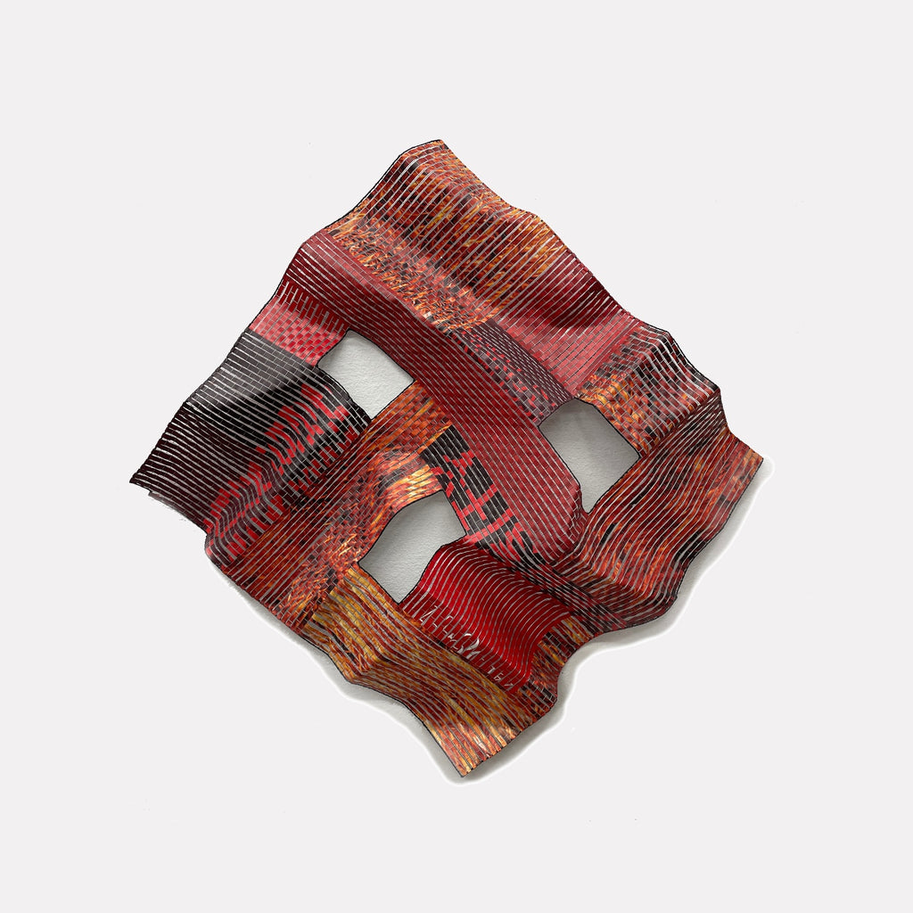 Hudson # 26 by Shelley Heffler is a Curina art piece featuring a folded, textured abstract form with bold red, black, and orange hues, layered with linear patterns and open spaces, creating a dynamic interplay of depth and movement in a sculptural composition.