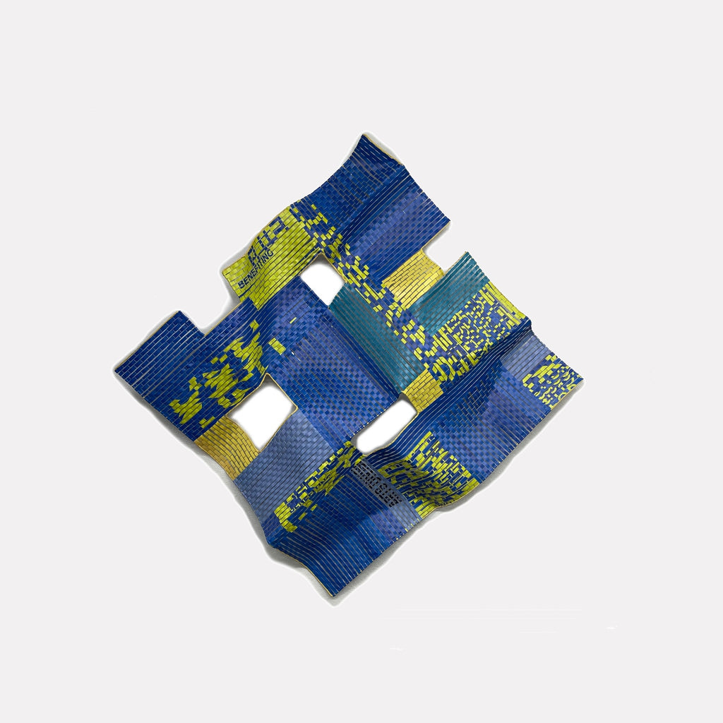 Hudson # 3 by Shelley Heffler is a Curina art piece featuring a textured, folded abstract form in vibrant blues and yellows with a grid-like pattern, conveying a dynamic, modern expression through its layered, sculptural design.