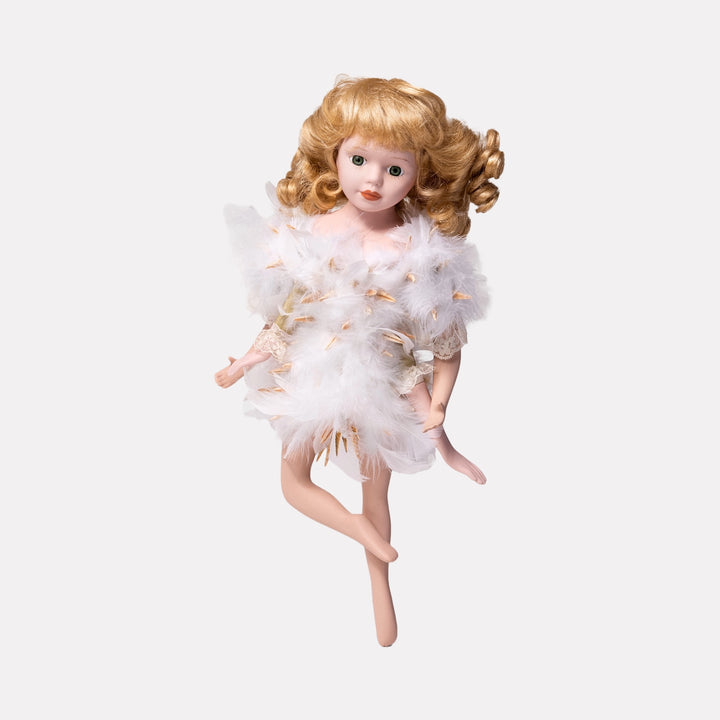 Magic Swan by Lisyanet Rodriguez features a delicate doll with porcelain skin and curly blonde hair, adorned in a white feathered costume with soft lace details, capturing a whimsical and elegant art piece for the Curina collection.