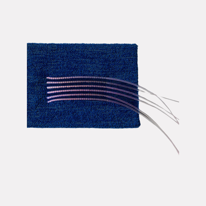 Ancient Futures (bug #2) by Craftwork features a textured deep blue rectangular base with delicate, translucent curved lines extending outward, creating a minimalist abstract design that balances organic movement and subtle modern artistry.