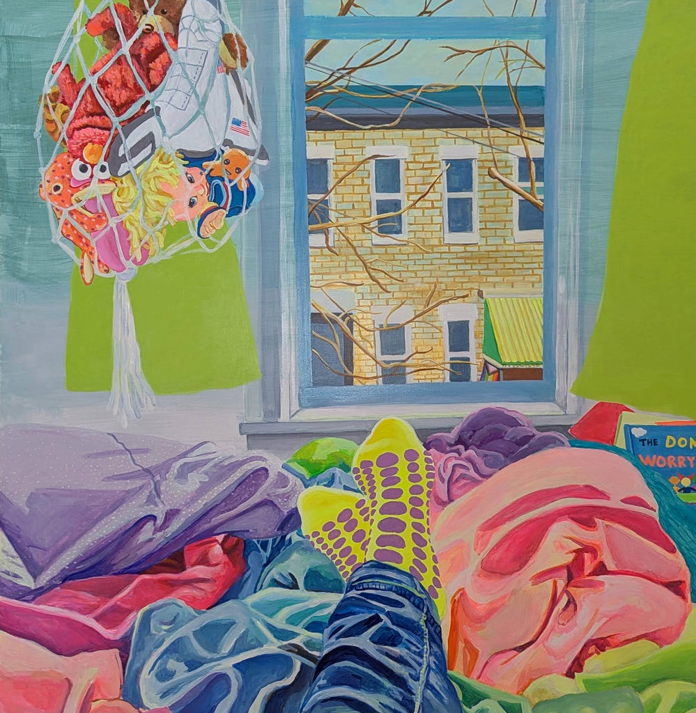 The artwork "She Keeps It All Together" by Mary Younkin depicts a cozy indoor scene with vibrant acrylic colors on a wood panel, featuring a view through a window of a brick building and leafless trees. Inside, colorful textiles, clothing, and socks with purple dots are scattered, creating a warm, lived-in atmosphere. Mary Younkin