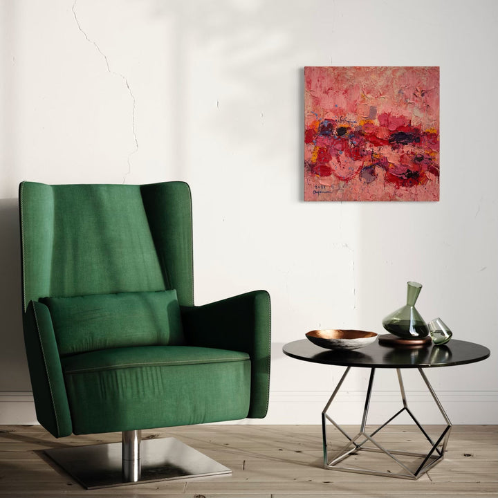 The artwork 'I Love Panda' by Ayane Kurai features vibrant abstract expressionist brushstrokes in shades of coral pink, deep red, and burgundy on canvas. The textured painting showcases dynamic movement and layered impasto technique, creating a passionate and energetic composition measuring 24x24 inches. The oil painting's rich palette and emotional depth create a striking focal point against neutral walls.