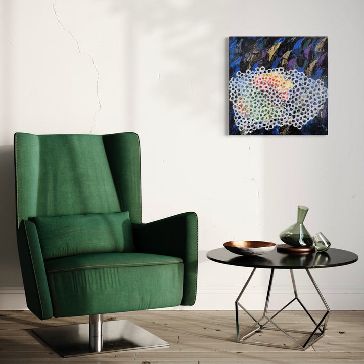 The artwork 'Hidden Thorns' by Ayane Kurai features a contemporary abstract composition with a honeycomb-like pattern in white dots against a dynamic background of deep blues and vibrant purples. Iridescent coral and peach hues peek through the geometric pattern, creating an organic flow across the 24x24 inch oil canvas, displayed above a modern green armchair. By Ayane Kurai.