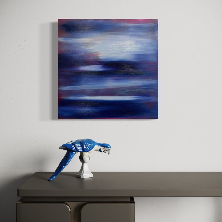 The artwork 'Serenity 4' by Bill Burns features ethereal horizontal brushstrokes in deep navy blues, soft lavenders, and misty grays creating an abstract atmospheric effect reminiscent of twilight skies. The oil painting on wood panel showcases fluid transitions between colors with subtle luminous qualities and dynamic movement across the 20x20 inch surface.