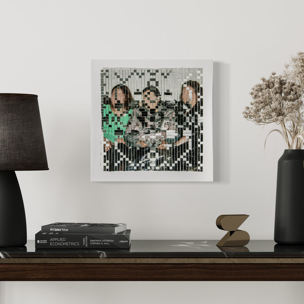 The artwork 'The Three Graces' by Kiana Honarmand features a pixelated abstract composition in a square format, combining hand-cut and woven giclee prints. The piece showcases a geometric pattern with vertical and horizontal lines in black, mint green, and gray tones, creating a glitch-like aesthetic within a white frame. 16x16 inches wall art.