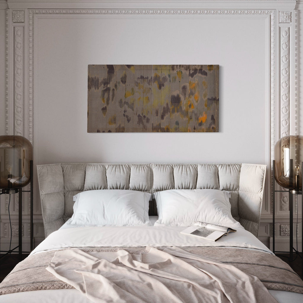 Untitled 8 by Victoria Manganiello features abstract patterns in muted gray tones with scattered golden yellow and orange accents, created using natural and synthetic fibers. The composition suggests a watercolor-like effect with organic shapes flowing across the 58x30 inch textile surface, blending dyed materials in a contemporary abstract style.