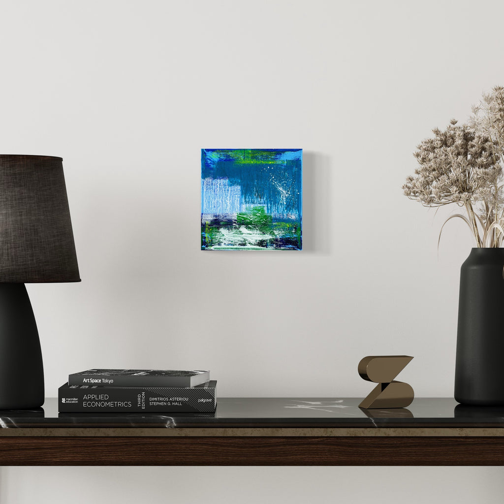 The artwork 'Voyage 12' by Bill Burns features a vibrant abstract composition on an 8x8 canvas. Bold strokes of electric blue and emerald green create a dynamic waterfall effect against white streaks, suggesting movement and fluidity. The acrylic painting evokes a coastal landscape with dripping textures and layered brushwork that blend into a mesmerizing aquatic scene by Bill Burns.