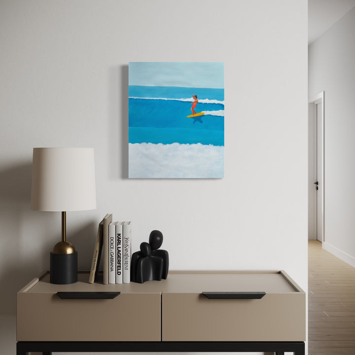 Smooth Glider by Alimo showcases a surfer dressed in red riding a yellow board through layered blue ocean waves, captured in a serene minimalist style that brings coastal energy and calm into a contemporary living space.