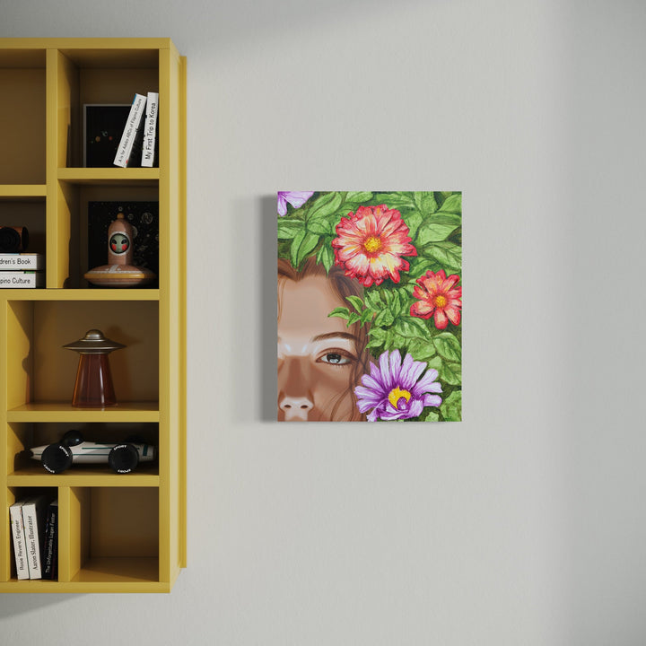 The artwork 'Amapola II' by Carlos Gamez de Francisco features vibrant floral elements with pink and purple blooms against lush green foliage. The acrylic on wood painting depicts tropical flora in a contemporary style, partially framing a partial profile view background. The 16x20 inch composition showcases rich botanical details and a soft neutral backdrop.