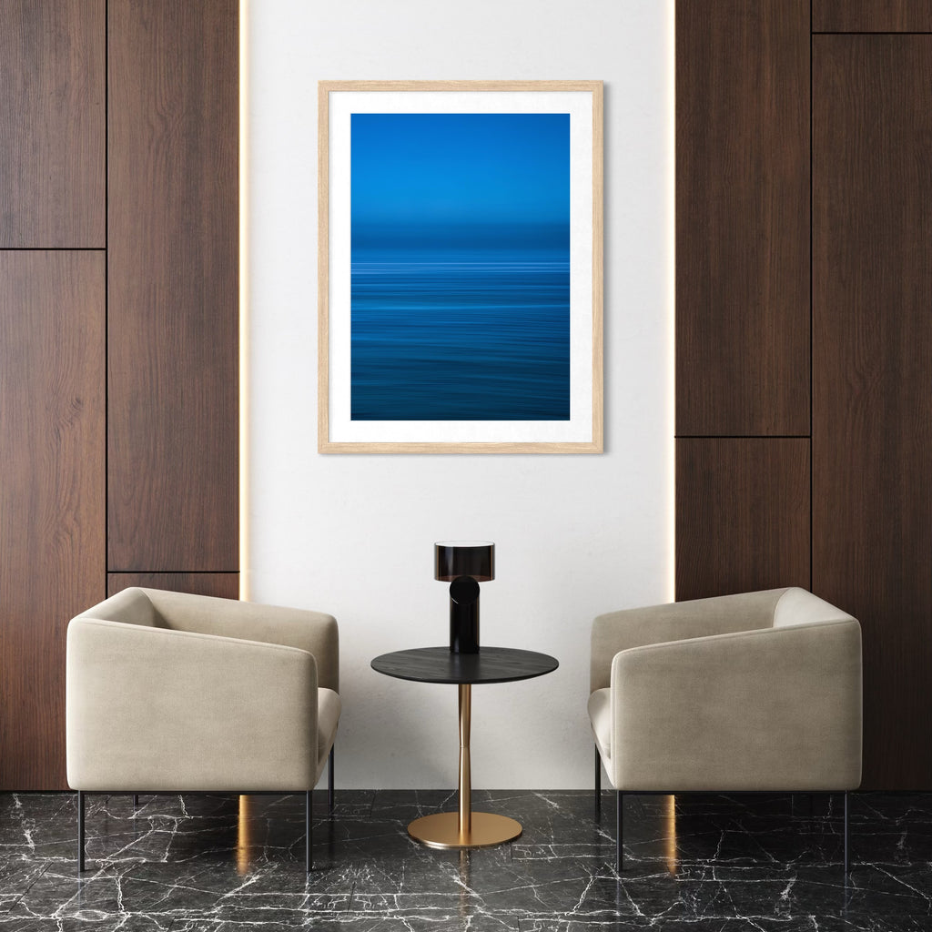 The artwork Blue Waters by Neil Shapiro features a tranquil abstract seascape with horizontal bands of deep and vibrant blues, suggesting the gentle movement of water and a calm horizon. The smooth gradients and minimalist composition evoke a meditative atmosphere reminiscent of Mark Rothko’s color fields and Agnes Martin’s subtle linear abstractions.