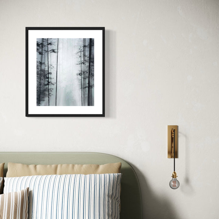 The artwork 'Breath of the Forest' by Cat Lencke features a misty black and white watercolor forest scene in a modern black frame. Tall, slender pine trees emerge from the fog, creating a minimalist composition with ethereal depth. The monochromatic palette emphasizes the mysterious atmosphere, while negative space suggests morning mist between the trees.
