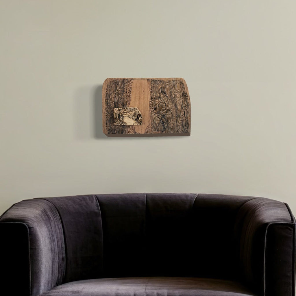 A photo of the artwork Burnt Offering - Mullica River, by Zoe Cohen, hanging on a wall.
