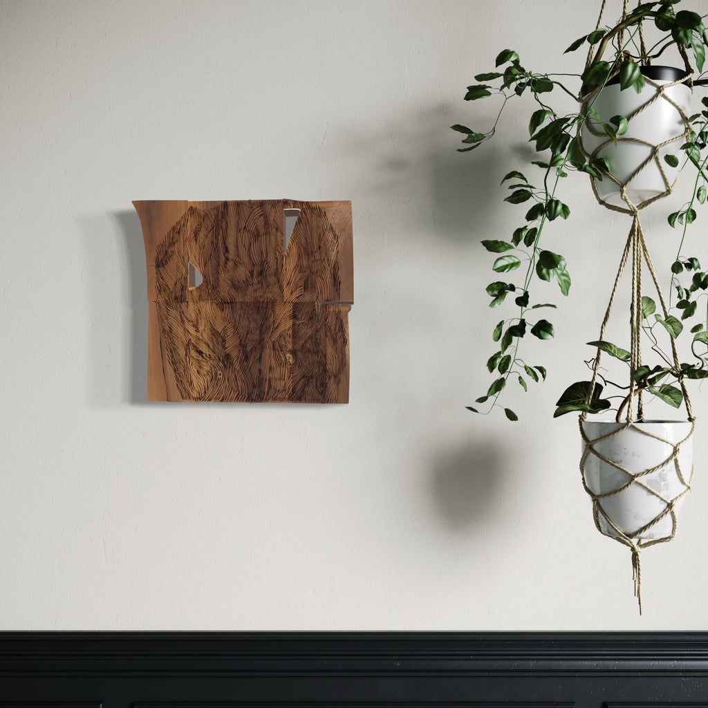 A photo of the artwork Burnt Offering 2, by Zoe Cohen, hanging on a wall.