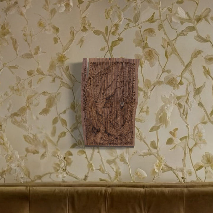A photo of the artwork Burnt Offering 4, by Zoe Cohen, hanging on a wall.