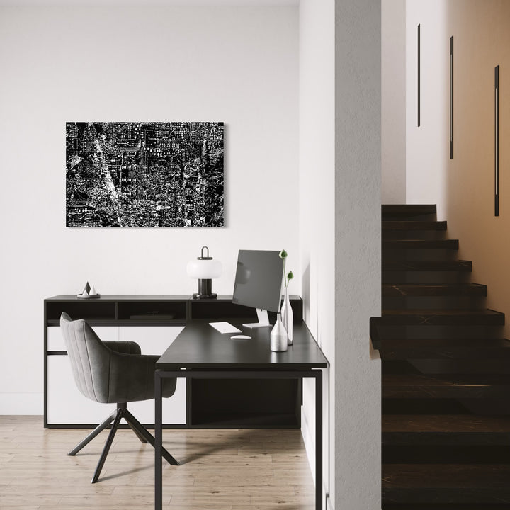 CYBERDYNE by Harold Herb showcases a dense, intricate black and white digital-inspired pattern mounted on a stark white wall above a modern black desk setup in a sleek, minimalist home office, merging cutting-edge abstract design with a clean, functional workspace environment.