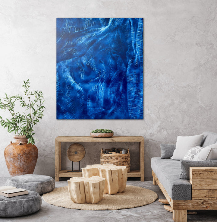 The artwork 'Dream Catcher' by Gina Iannucci features ethereal swirls and textural patterns in deep sapphire blue spray paint on canvas. Abstract waves and rippling effects create a mesmerizing oceanic atmosphere, with varying shades of cobalt and azure blending seamlessly across the rectangular surface. The dynamic brushstrokes suggest movement and depth, measuring 35.25 x 41.25 inches.