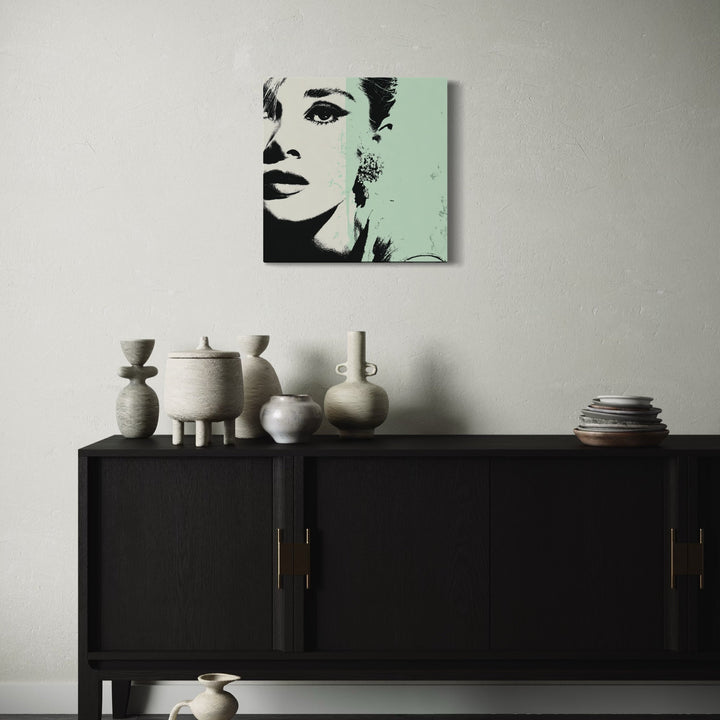 The artwork, Grey Green Woman, by Claudia Sauter, displayed in a room.