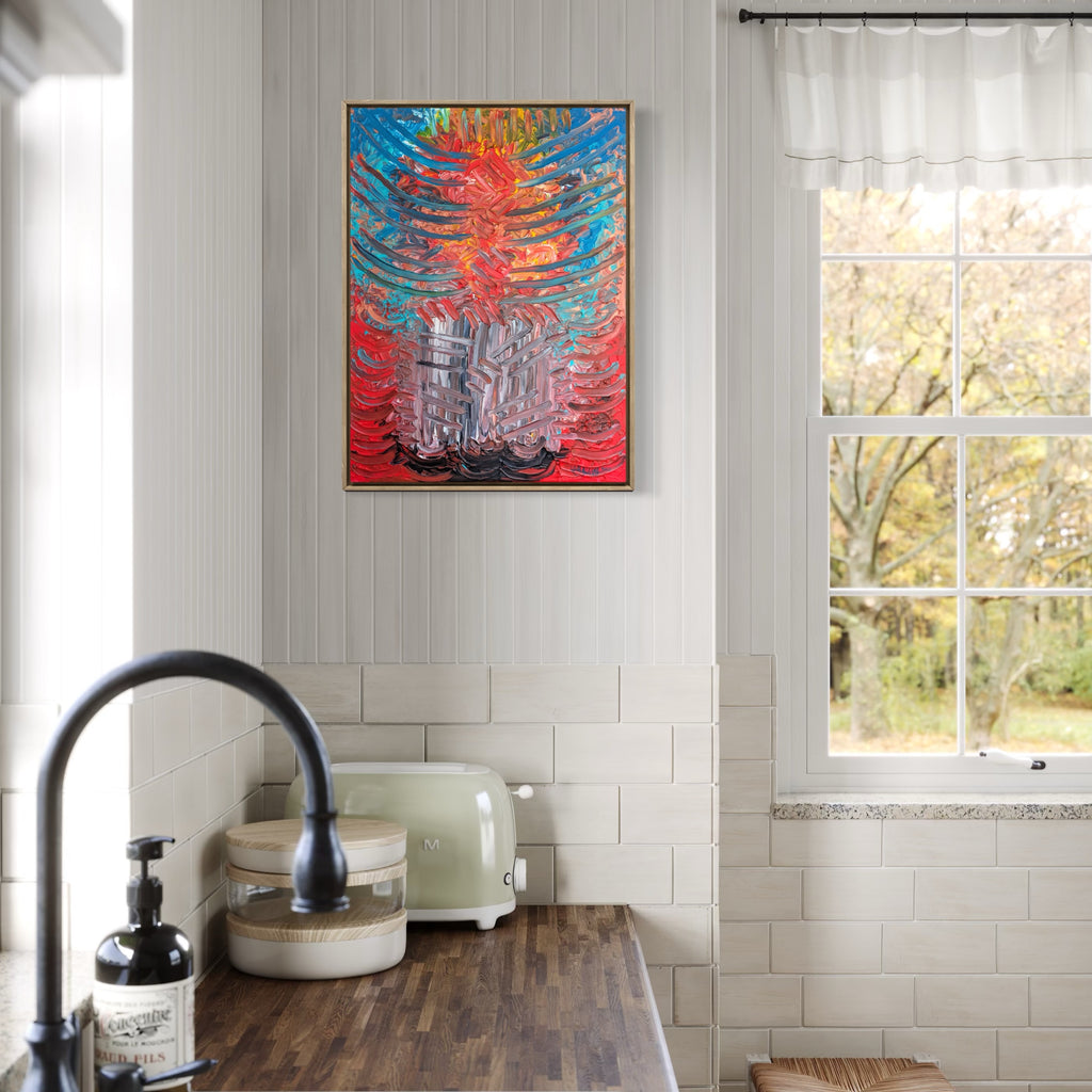 Gutted by Grief by Hillary Hany showcases a vivid abstract design with intense reds, blues, and grays, featuring layered, dynamic strokes that convey emotional depth. Displayed in a bright kitchen space above a wooden countertop near a window, it adds a bold, expressive accent to the neutral-toned room.