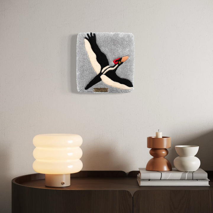 The artwork, Ivory Billed Woodpecker, by Abigail Henthorne, displayed in a room.