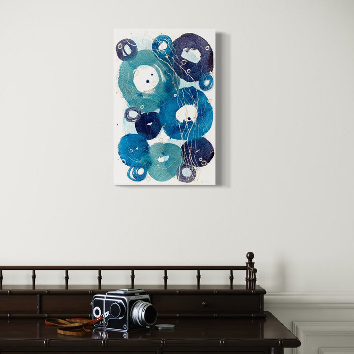 The artwork 'Little Ripples I' by Jocelyn Benford features organic circular forms in varying shades of turquoise and navy blue, creating a flowing watercolor composition. The abstract bubbles overlap and merge, with white negative spaces adding depth and movement. Mixed media elements enhance the texture on white paper, measuring 23x15 inches.