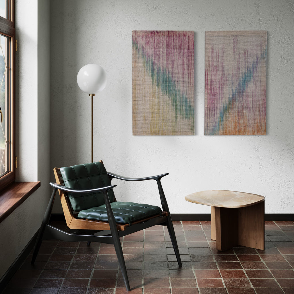 The artwork 'Margo' by Victoria Manganiello features a diptych of woven textiles with ethereal color gradients. Each panel displays a delicate interplay of muted turquoise, dusty rose, and warm amber hues bleeding into natural linen. The textural weave creates subtle vertical striations across both 42-inch panels, showcasing masterful fiber dyeing techniques and contemporary textile artistry.