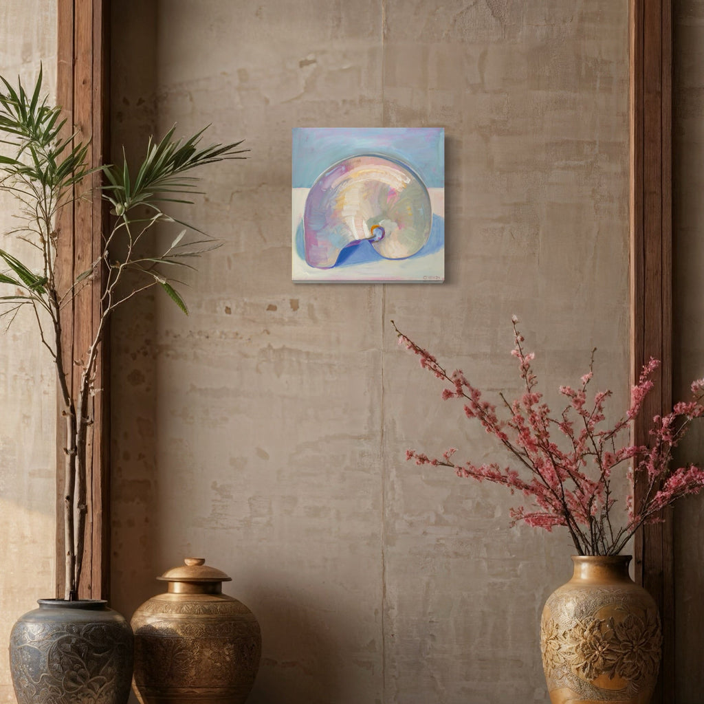 The artwork 'Nautilus' by Cristi Lyon features a luminescent seashell rendered in oil on canvas, displaying soft pastel hues of lavender, blue, and cream. The spiral shell form is painted with delicate brushstrokes, creating an iridescent effect against a serene blue-tinted background, capturing the natural beauty and mathematical perfection of nautilus geometry.