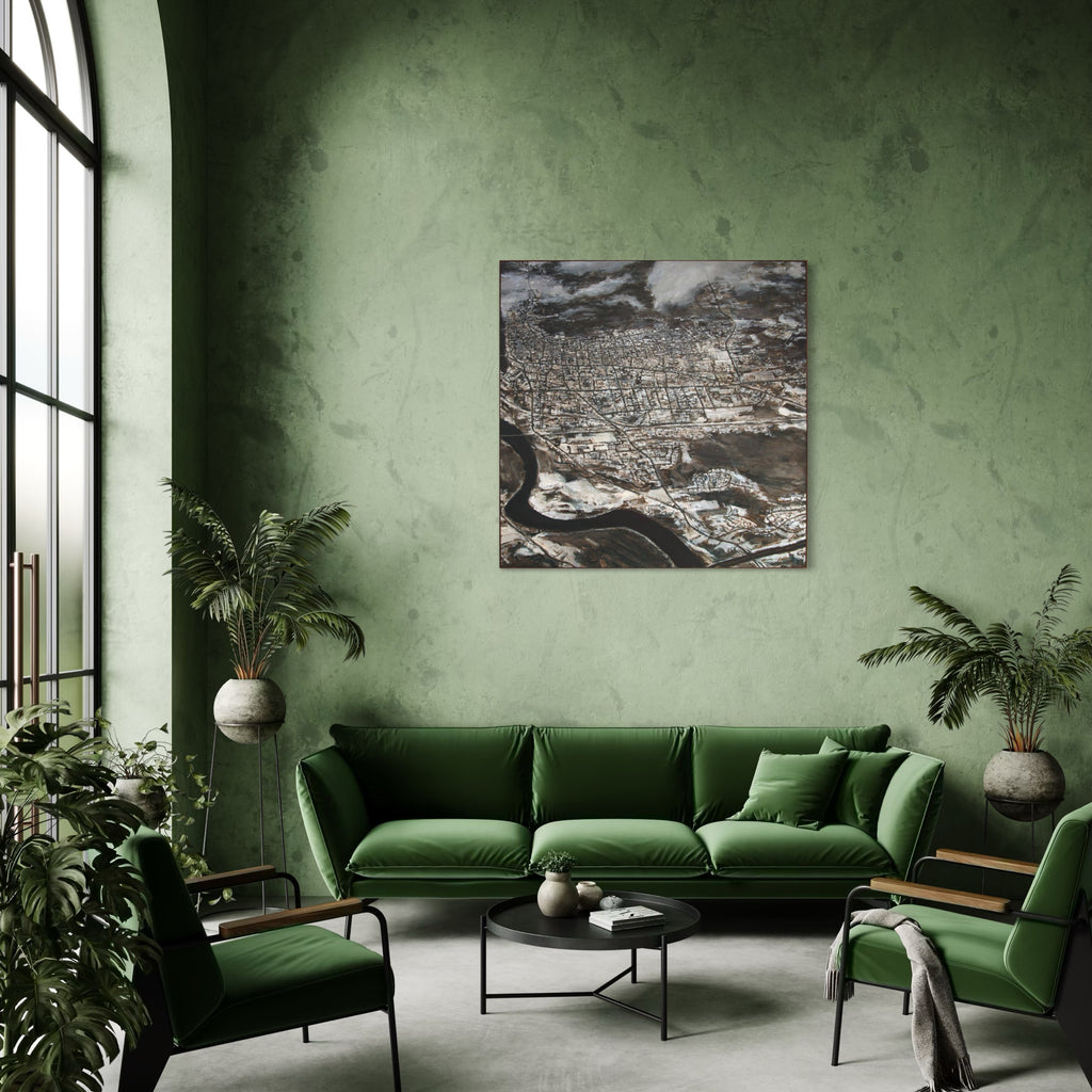 The artwork 'New England Thaw' by Christopher Blyth depicts an aerial view of a snow-covered New England town with intricate street patterns and urban development alongside a winding river. The oil painting utilizes a monochromatic palette of browns, whites, and grays, creating a stark winter landscape with detailed architectural elements and dramatic cloud formations.