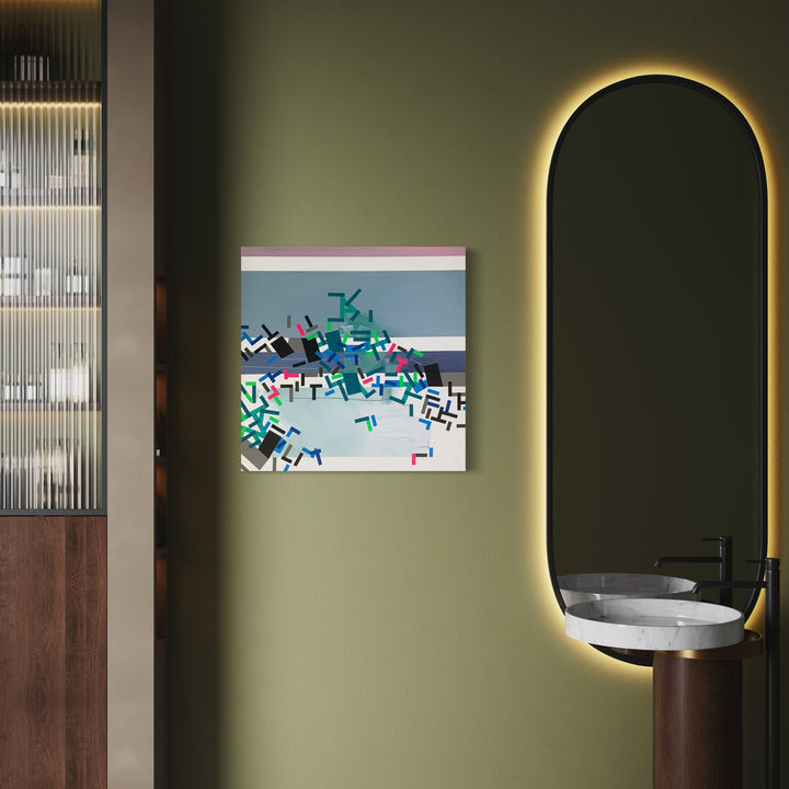 The artwork 'Oolffovva' by Philippe Halaburda features abstract geometric shapes scattered across a light blue background. The composition includes angular forms in teal, red, and black, creating a dynamic pattern resembling scattered puzzle pieces. The 30x30 inch acrylic and tape on canvas artwork combines precise lines with playful arrangement, displayed against a sage green wall.